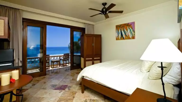 Modern, comfortable, beachfront rooms at the Cabo Surf Hotel in Baja California have comforters, marble floors, and cedar carpentry