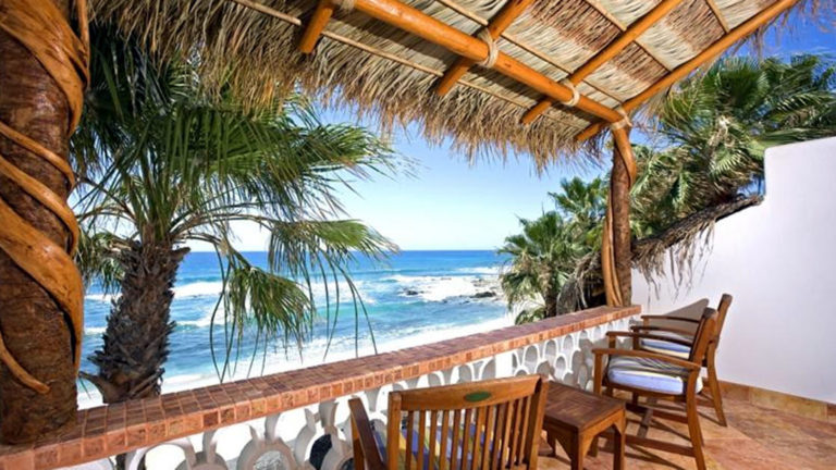 At the Cabo Surf Hotel and Spa in Los Cabos, Baja, guests can sit on chairs on a shaded balcony with a thatched roof to hear the soothing sound of waves crashing in the ocean