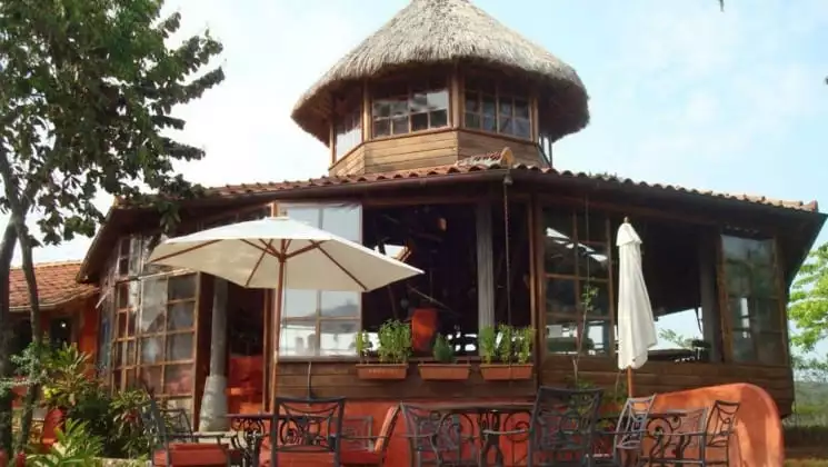One of the private bungalows at the Cala Mia Boutique Hotel with a thatched roof, outdoor 