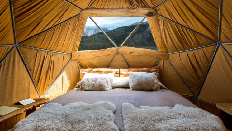 Double bed with skylight and mountain views in Standard Dome at EcoCamp in Patagonia, Chile