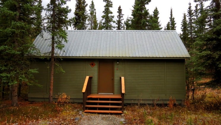Front of guest cabin surrounded by trees at Denali Education Center near Alaska's Denali National Park