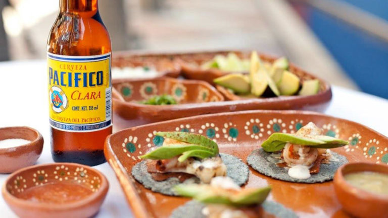 A bottle of Pacifico beer and fresh ceviche appetizers topped with avocado at Casa Natalia boutique hotel in San Jose del Cabo on the Baja Peninsula