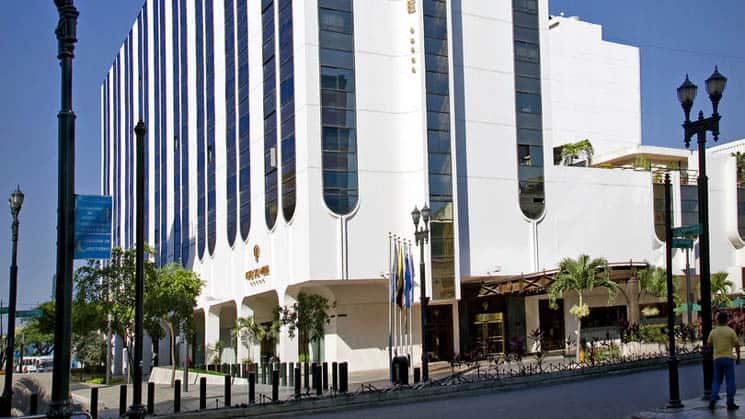 The exterior of the white, high-rise building that is the Hotel Oro Verde, located in downtown Guayaquil, Ecuador