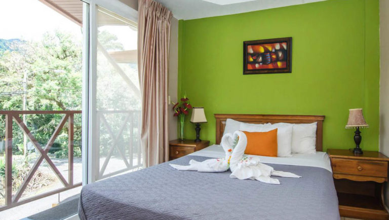 A single room with a queen-sized bed and a patio at La Casa de la Abuela, a cozy hotel in the Caldera river valley in Panama