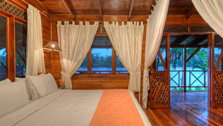 The River View Penthouse Suite with a king-sized bed and a river-facing front porch with hammocks and rocking chairs, at the Tortuga Lodge, one of Costa Rica's most environmentally conscious accommodations.