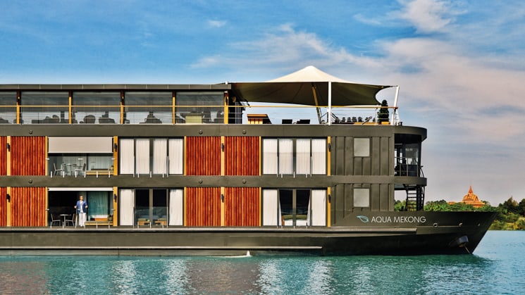 Starboard side of the luxury Aqua Mekong Amazon riverboat with large windows and top deck lounge.