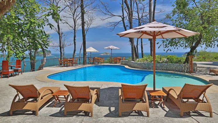 The pool and lounge chairs at Arenas Del Mar, a luxury lodge in Costa Rica.