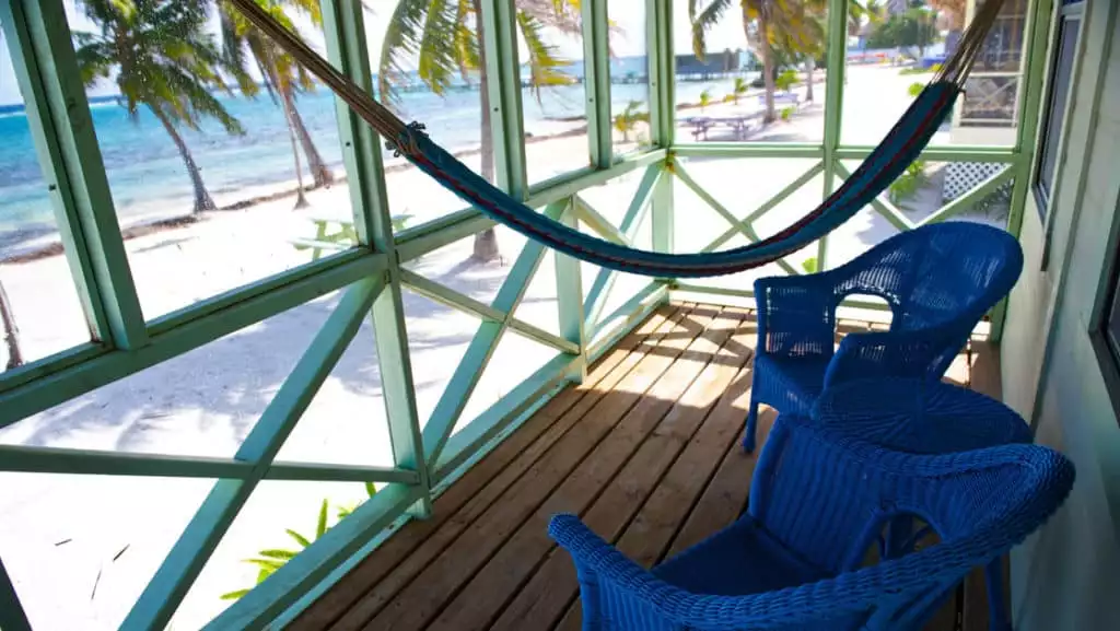 A screened porch on one of Blackbird Caye's cabanas.
