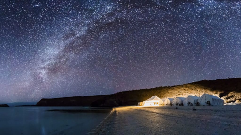 Camp Cecil de la Isla is lit up at night, with a beach for stargazing at the Milky Way, on the pristine and wildly beautiful Isla Espiritu Santo, part of a National Marine Park and UNESCO World Heritage Site.