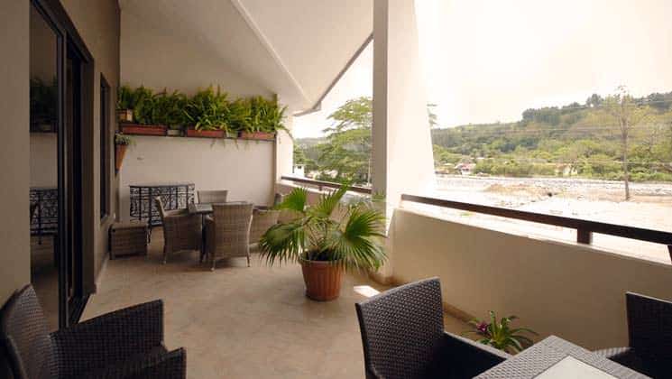 patio area with chairs and potted plants overlooking the town at hotel ladera in panama
