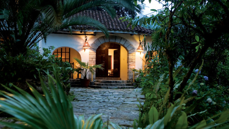 The arched entrance to the Inkaterra Machu Picchu Pueblo Hotel, a National Geographic Unique Lodge of the World in the Andes with 83 whitewashed adobe casitas tucked away in the cloud forest.