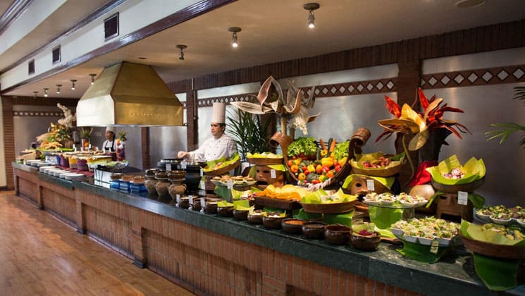 buffet line with colorful food and chefs behind the counter at the las americas hotel in guatemala