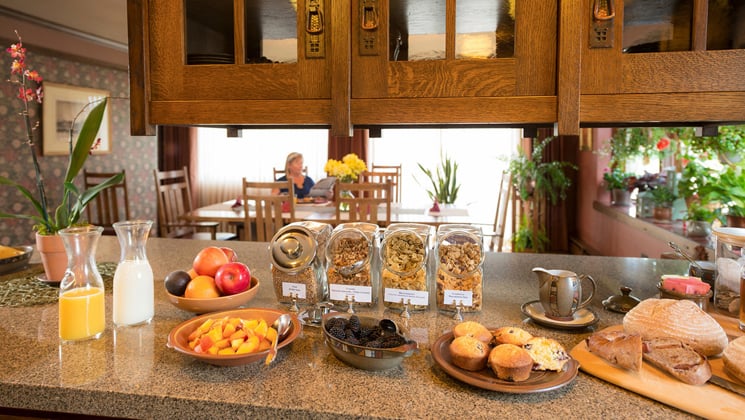 The breakfast buffet features orange juice, milk, cereal, and fresh bread at the Parkside Guest House, a family-owned hotel in Anchorage Alaska