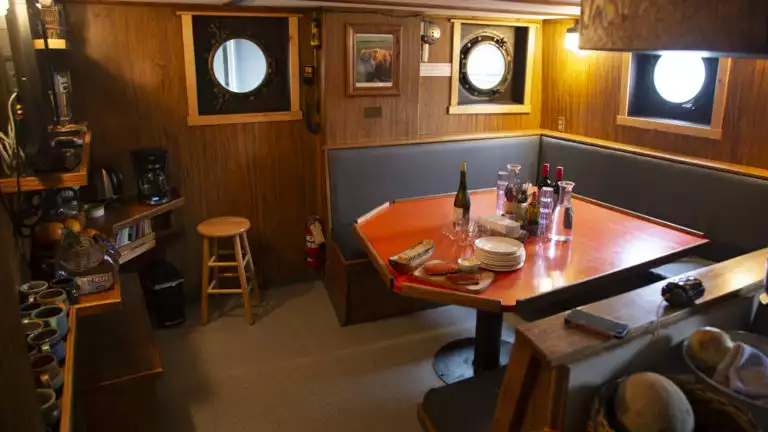 Dining table and bar area aboard Ursus.