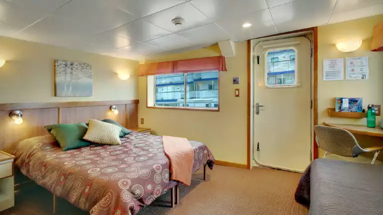 Admiral cabin with queen bed aboard Wilderness Discoverer