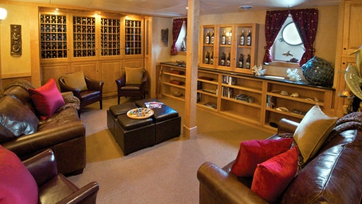 wine library with bottles on the walls and chairs surrounding the room aboard the Safari Explorer Hawaii small ship
