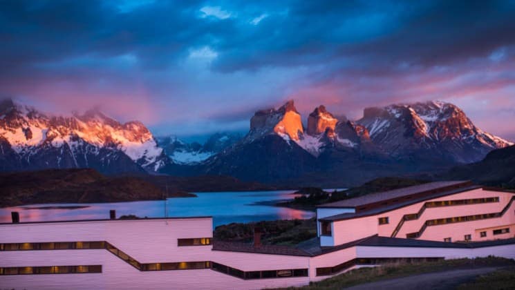 Purple alpenglow hues in the sky as the sun sets on Explora Torres del Paine Lodge in Chile