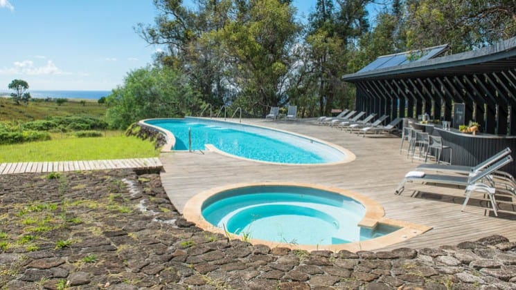 Outdoor pool and hot tub with lounging chairs at Explora Rapa Nui Lodge on Easter Island