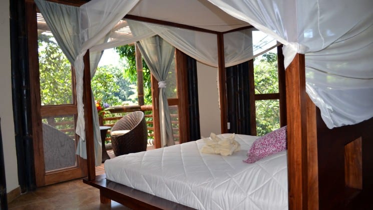 The Superior Suite at La Selva Amazon EcoLodge, a sustainable, luxury accommodation in the Ecuadorian Amazon basin, with a king-sized bed and a private balcony