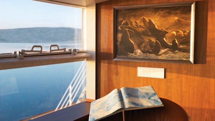 Ocean exhibit with sea lion photo and book in library aboard National Geographic Explorer polar expedition ship