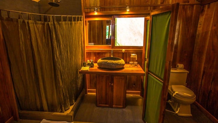 Bathroom with shower, sink, mirror and toilet in tent cabin at Galapagos Safari Camp Santa Cruz Highlands in the Galapagos Islands