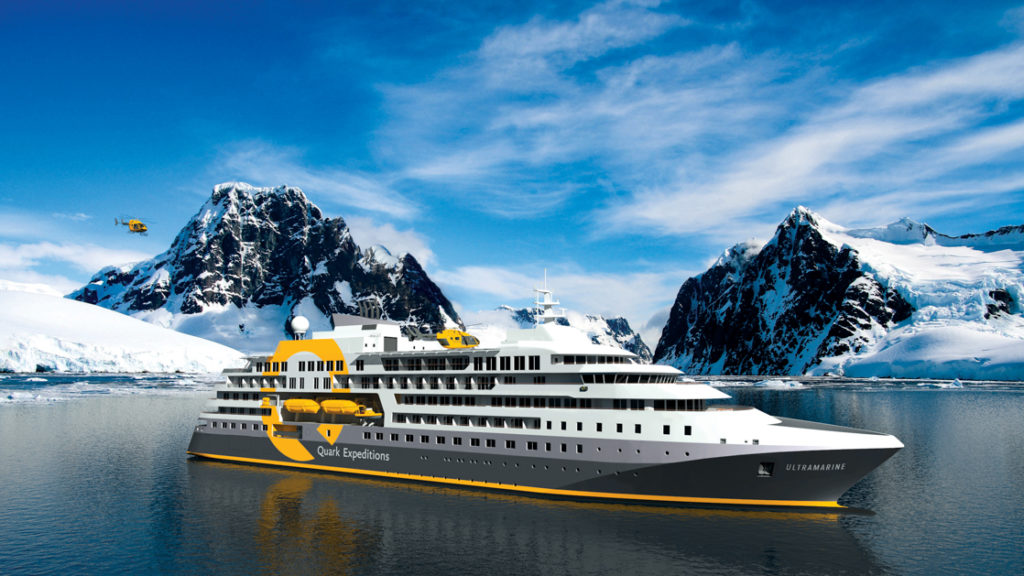 Exterior of Ultramarine polar expedition ship, starboard side, with snowy peaks in the background on a sunny day.