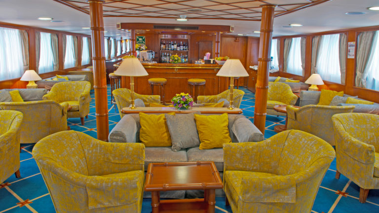 Lounge with many chairs and bar aboard Callisto.