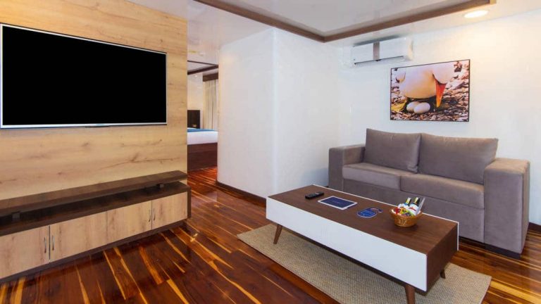 large living suite with TV and couch and coffee table aboard the Cormorant in the Galapagos
