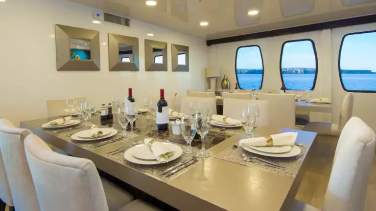 Two set tables in dining room aboard Alya.