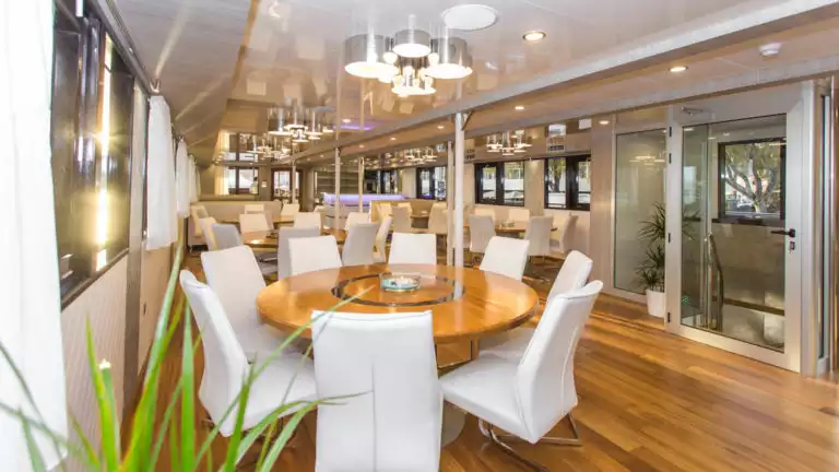Maritimo Dining Room with tables, chairs and windows with a contemporary fee.
