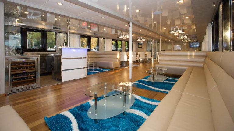 Maritimo lounge with bar, banquette seating, coffee tables and large picture windows.