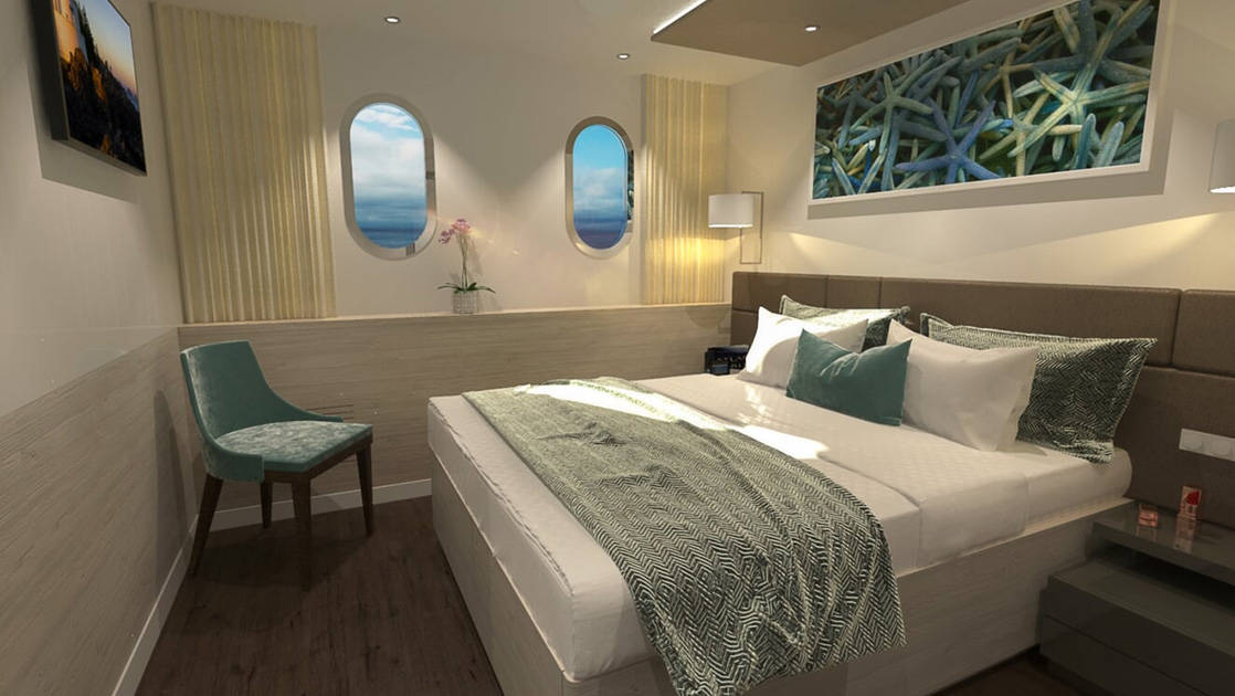 Nautilus Mediterranean yacht Main Deck cabin with two oval windows, double bed, sea star photo above bed, TV on wall, chair & blue-and-teal accents.