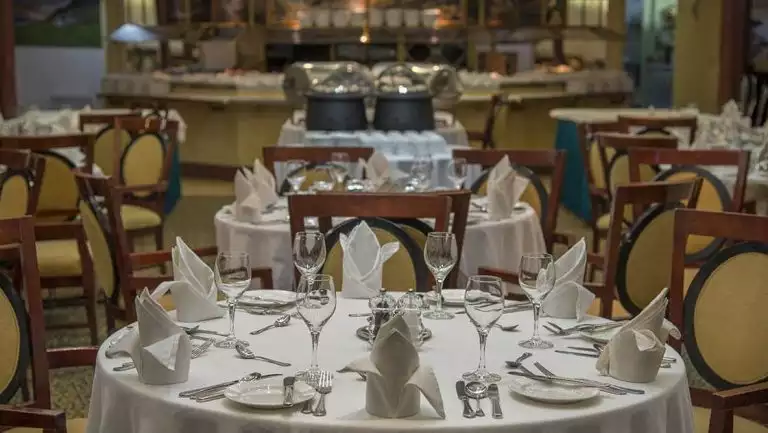 Dining room with glasses, plates, cutlery and chairs aboard the Ocean Diamond