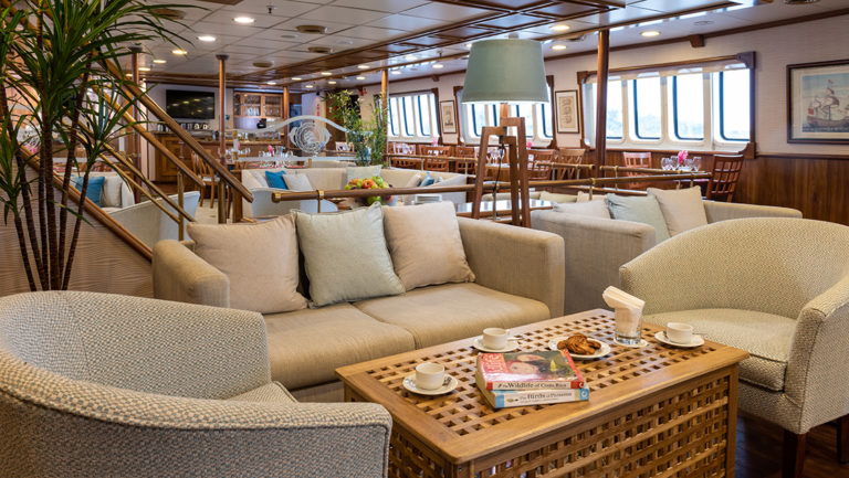 Panorama Mediterranean luxury yacht lounge with a plush sofa and comfortable chairs