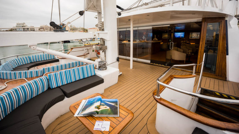 outside deck with a table and bench aboard the Panorama Mediterranean luxury yachtPanorama Mediterranean luxury yacht