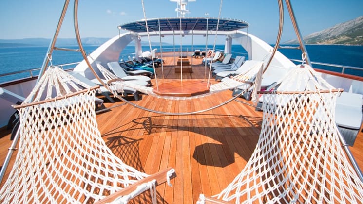 Lounge chairs and hammocks on the sun deck aboard Admiral.
