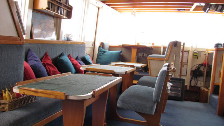 Sitting area and table aboard the Affinity.