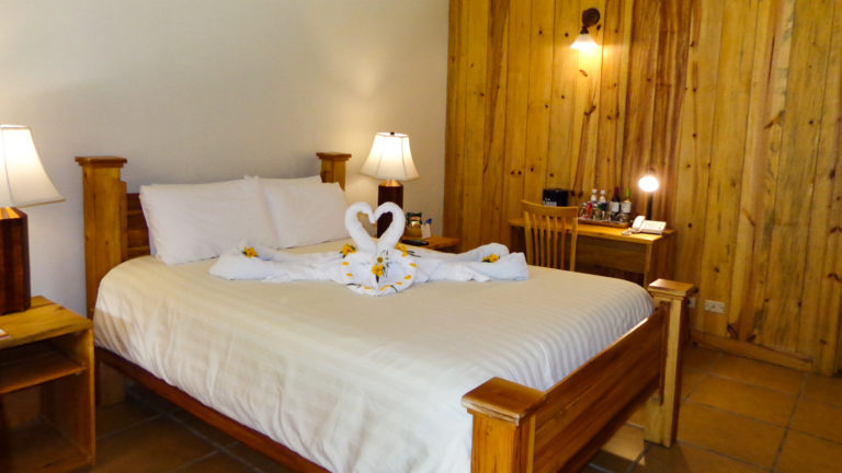 A queen bed in a room at Boquete Tree Trek Mountain Resort.