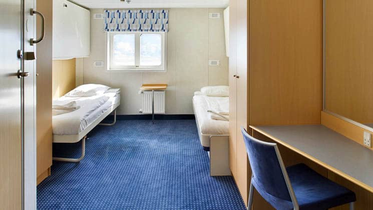 Ocean Nova room with 2 beds, a window and blue carpet
