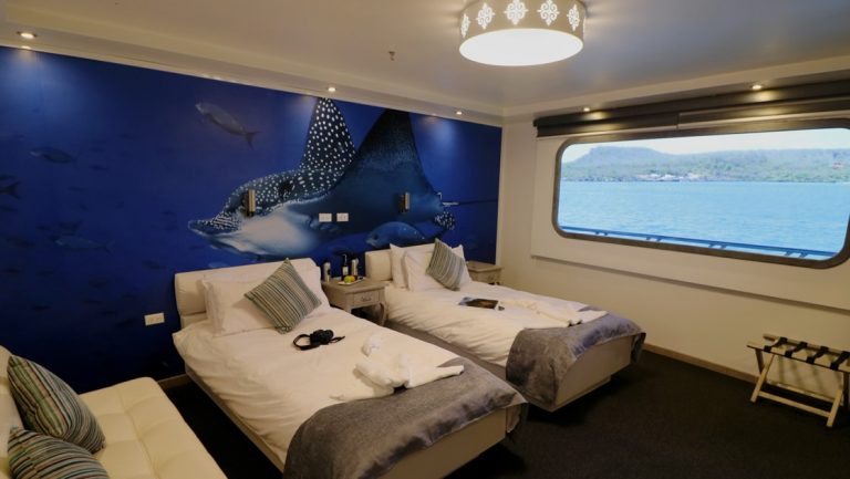 Stateroom with twin beds and windows aboard Galapagos Horizon