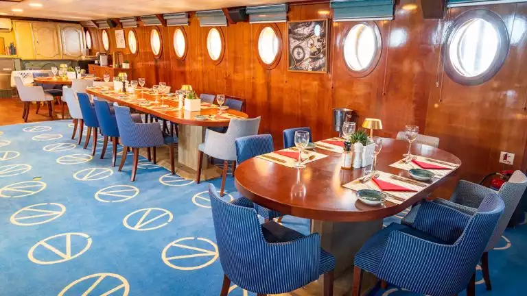 Beautiful dining room featuring plush carpet and chairs aboard the Galileo while cruising the Aegean sea Mediterranean