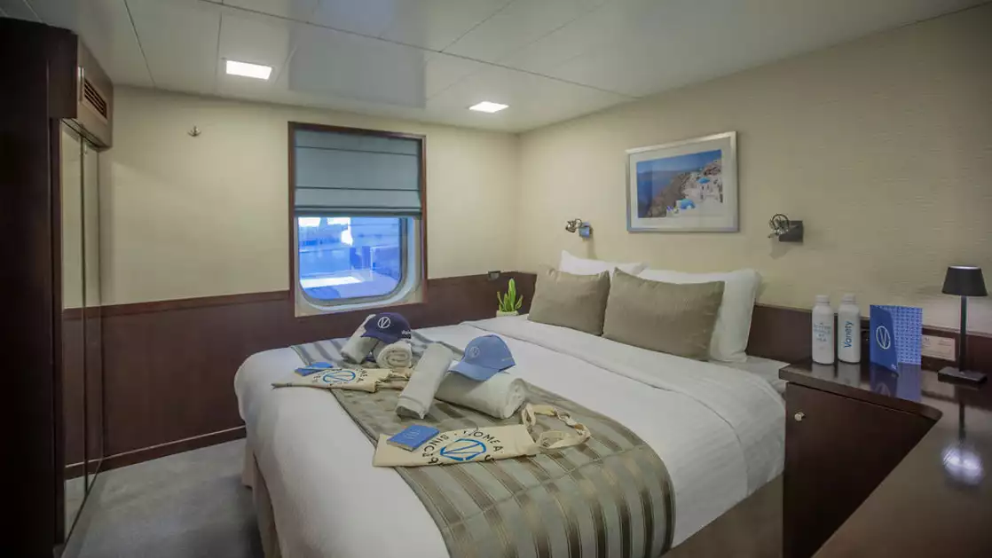 Harmony A yacht Category B stateroom with double bed, 2 windows, desk and reading lights