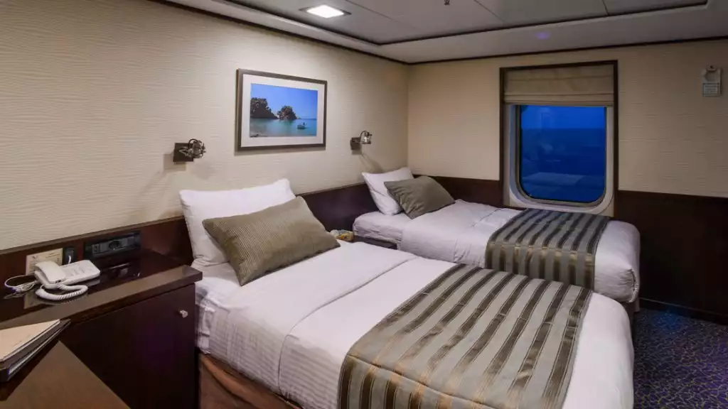 Category P stateroom with twin beds aboard Harmony V