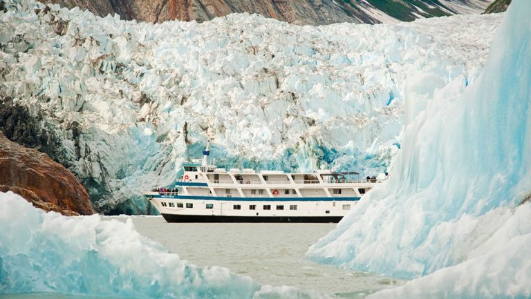 Small ship Admiralty Dream cruises Glacier Bay National Park among giant icy blue crystal glaciers in Alaska.