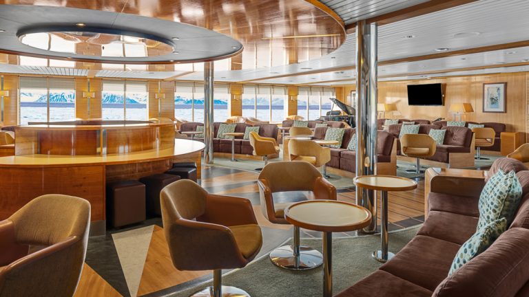 In the ships lounge aboard the National Geographic Explorer you will sit in comfort with captains chairs and benches