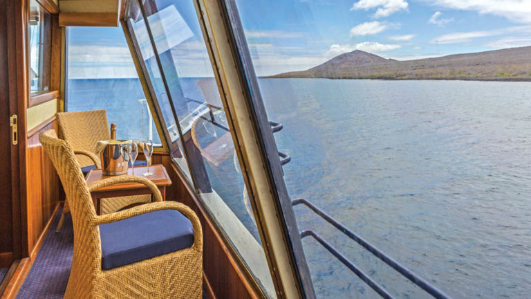 Table and chairs on private balcony aboard National Geographic Islander expedition ship in Galapagos Islands