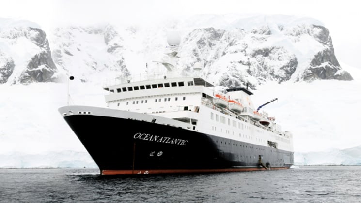 ocean atlantic polar vessel on an overcast day with snow in the background