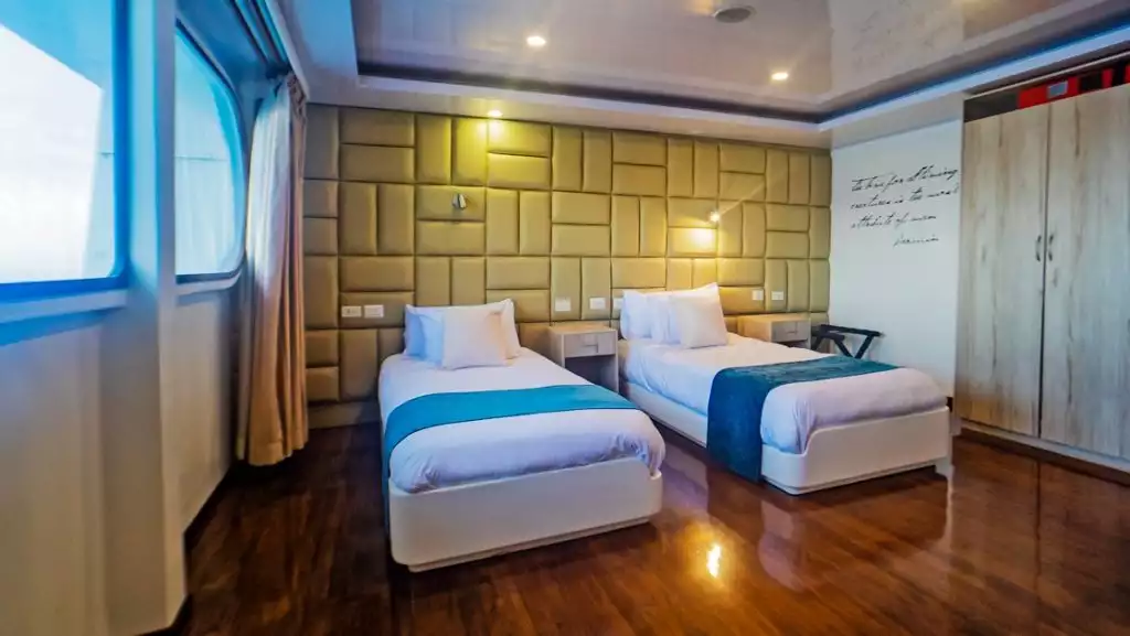 Golden Stateroom with twin beds aboard Petrel