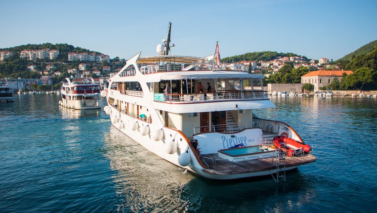 prestige mediterranean luxury yacht at harbor with swim equipment on the back deck