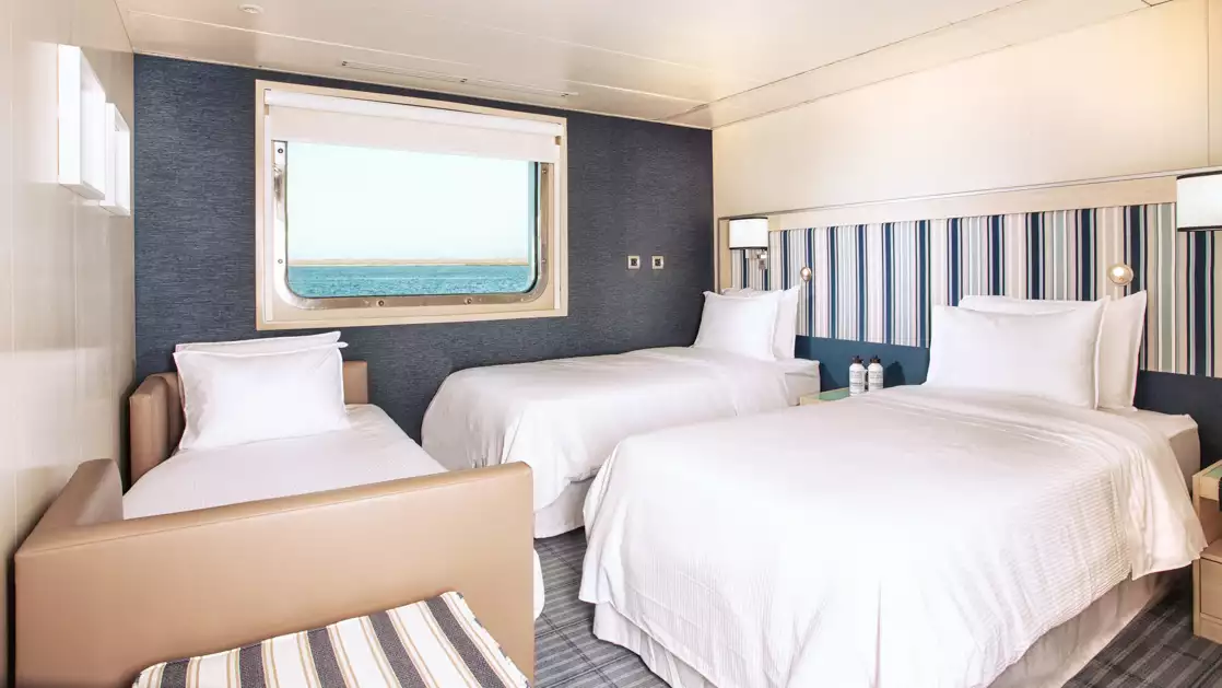 A room featuring three beds to accommodate you and your family in comfort aboard the Santa Cruz II sailing the Galapagos Isles.